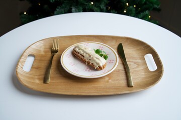 Eclair with vanilla sauce and crispy chips. European desserts.