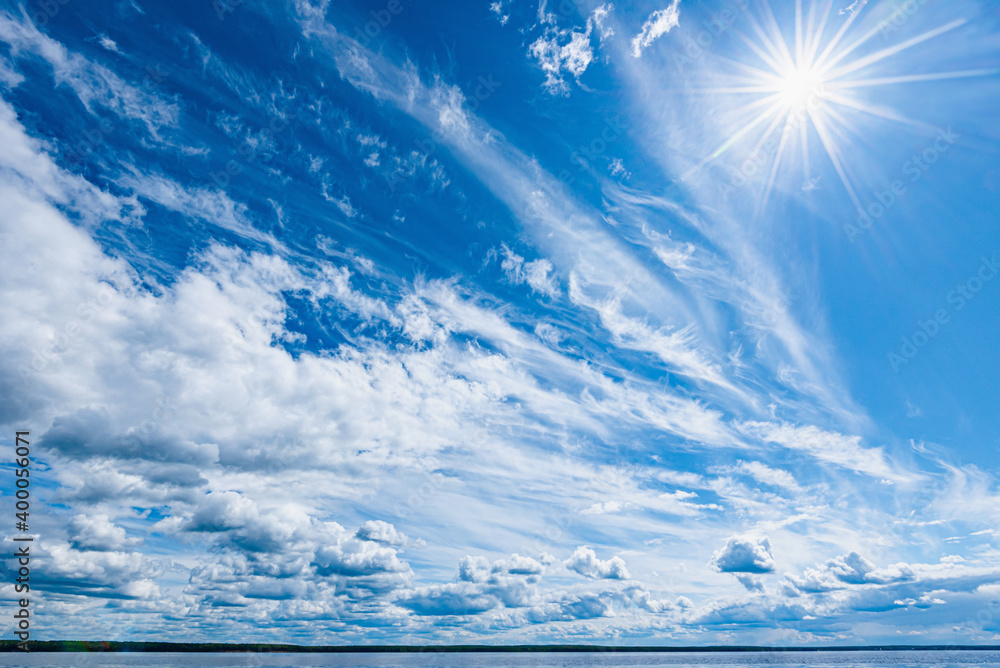 Wall mural panorama of calm lake, kama river blue sky with clouds reflected in the water.