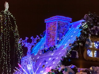 Christmas decoration of the roof of the hut at night.