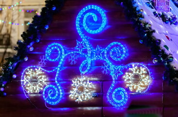 Christmas decoration of the roof of the hut at night.