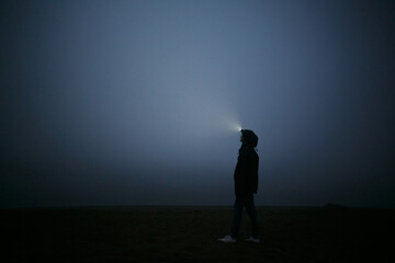 Girl at night in the fog.