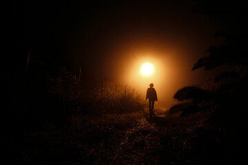 Girl at night in the fog.