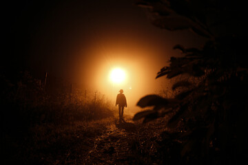 Girl at night in the fog.
