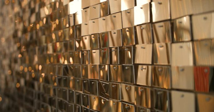 Gold sequin fabric for party. Holiday abstract glitter background with blinking lights. Fashion luxury fabric glitter, spangles, paillettes