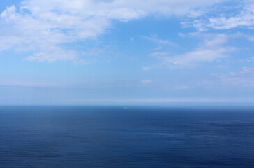 Colorful landscape with endless sea and beautiful clouds in the blue sky