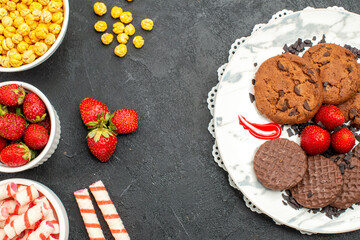 top view yummy choco biscuits with candies on dark background sweet sugar cake cookies