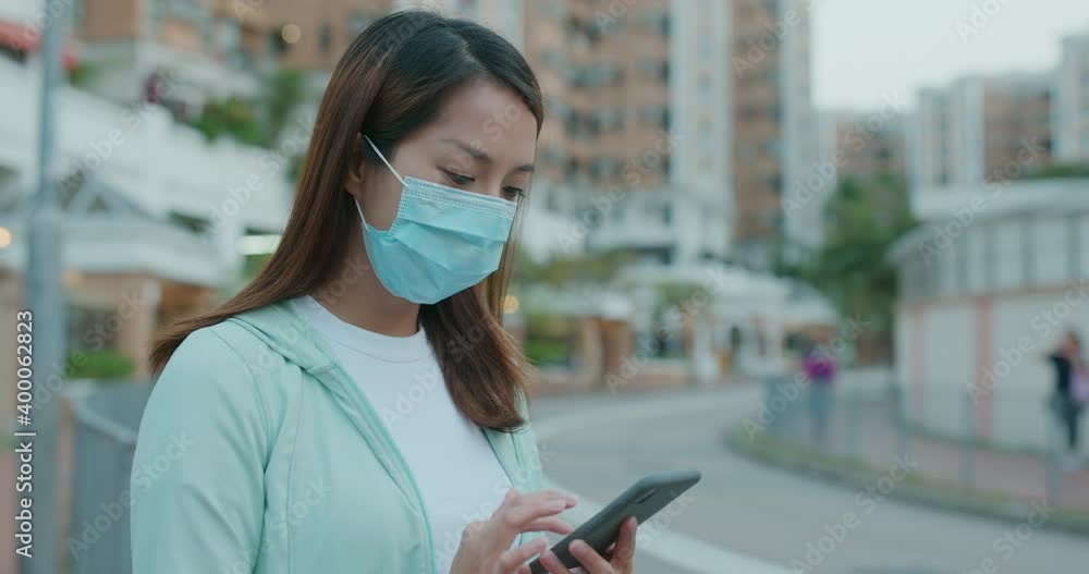 Poster Woman wear face mask and use of mobile phone at street