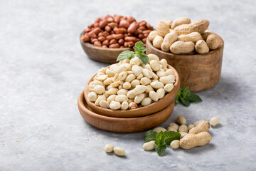 Raw dried fresh peanut nuts on a stone background