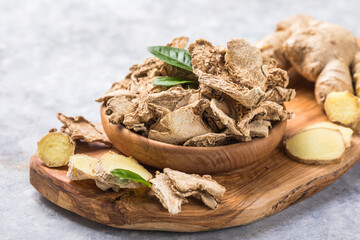 Slices of ginger dried fruit  and ginger root on a stone table. Against viruses and diseases. immune product.