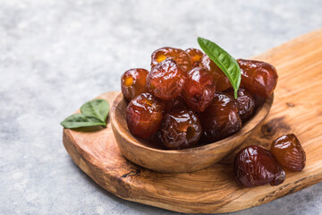 Dates or dattes palm fruit in wooden bowl is snack healthy.Creative layout made of dried dates. Flat lay. Food concept. Fruits dates. Dates Palm fruit isolated on white. Dried fruits. Healthy diet.