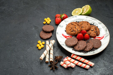 top view yummy choco biscuits for tea on dark desk sweet cookie sugar tea