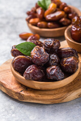 Dates or dattes palm fruit in wooden bowl is snack healthy.Creative layout made of dried dates....