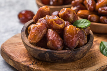 Dates or dattes palm fruit in wooden bowl is snack healthy.Creative layout made of dried dates. Flat lay. Food concept. Fruits dates. Dates Palm fruit isolated on white. Dried fruits. Healthy diet.