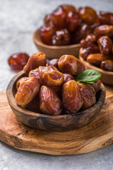 Dates or dattes palm fruit in wooden bowl is snack healthy.Creative layout made of dried dates. Flat lay. Food concept. Fruits dates. Dates Palm fruit isolated on white. Dried fruits. Healthy diet.