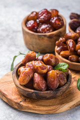 Dates or dattes palm fruit in wooden bowl is snack healthy.Creative layout made of dried dates....