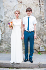 Bride and groom walking in old city