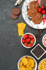top view yummy choco biscuits with different snacks on dark floor sweet cookie tea
