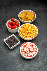 front view different eatings crackers fruits and candies on dark background photo sweet crisp tea