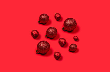 Red Christmas balls laid out in the form of circle on bright background.