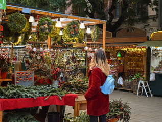 Woman buying some souvenirs at a Christmas market.