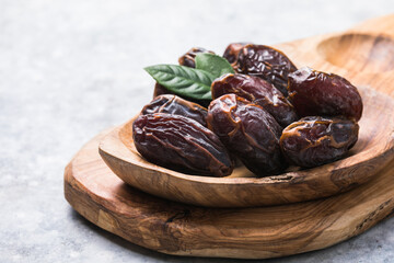 Beautiful juicy date with water drops. Fresh dates plucked from a tree in a plate. Dried dates on a...