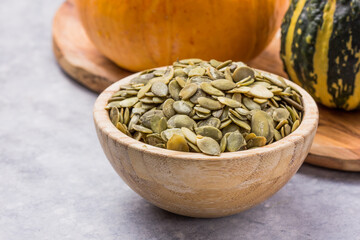 Pumpkin seeds (peeled seeds) on white background.