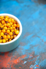 bottom half view sea buckthorn on blue table