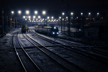 Fototapeta na wymiar railway station with trains at night in blue tone