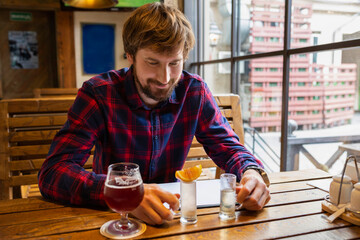 Happy man sits a bar alone. Alcoholism and the fight against alcohol addiction. Lifestyle