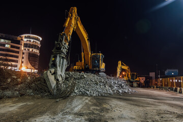 Hydraulic excavator clears the debris of demolished building