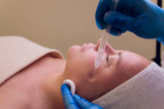 Skin Care. Beautiful Healthy Woman Getting Her Skin Analized By Cosmetologist, Using Skin Analyzer Professional Beauty Equipment For Face Skin Analysis At Cosmetology Center.