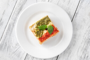 Portion of lasagne on white plate