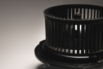 Heater motor. A spare part for an automobile heating system on a black-gray gradient background....