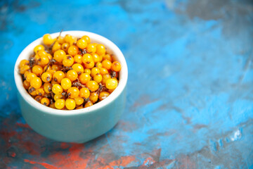 bottom view sea buckthorn on blue table free space