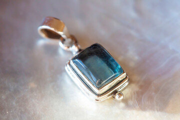 Silver pendant with natural mineral stone on natural background