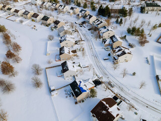 Aerial view of residential houses covered snow at winter season with snow on covered houses and roads.