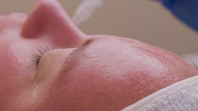 Skin Care. Beautiful Healthy Woman Getting Her Skin Analized By Cosmetologist, Using Skin Analyzer Professional Beauty Equipment For Face Skin Analysis At Cosmetology Center.