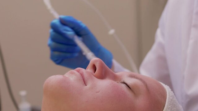 Skin Care. Beautiful Healthy Woman Getting Her Skin Analized By Cosmetologist, Using Skin Analyzer Professional Beauty Equipment For Face Skin Analysis At Cosmetology Center.