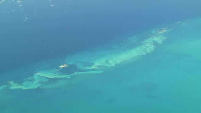 Flying over The Bahamas. Beautiful ocean colors. Actual aerial footage.
Aerial footage of isolated islands in The Bahamas. Actual high altitude footage.