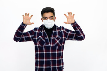 Handsome young man male model. He is wearing a medical mask and a dark checkered shirt.