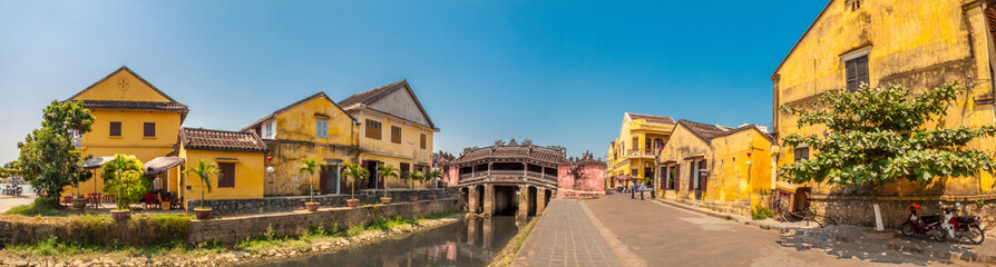 Fototapeta na wymiar Wide view of the Japanese Covered Bridge and surrounding buildings, Hoi An, Vietnam