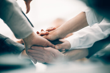 close up. a group of business people joining their palms together