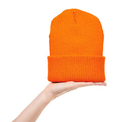 Hand with orange winter hat isolated on white background.
