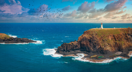 lighthouse in hawaii on rocks with coastline