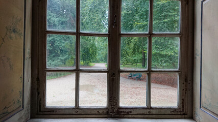 A look at the empty alleys of the park through a closed window