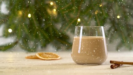 Snow is falling on Eggnog - Christmas drink with milk, rum, cinnamon and nutmeg. - Powered by Adobe