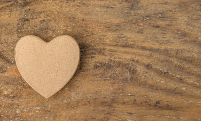 
Cardboard heart on a wooden table