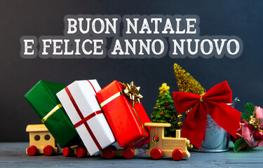 Merry Christmas and happy New Year in italian holidays card, presents box and gift in the color of...