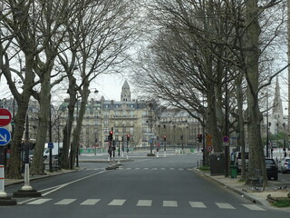 calle de Par&iacute;s totalmente vac&iacute;a por cuarentena de coronavirus. Perspectiva con &aacute;rboles y se&ntilde;ales de tr&aacute;nsito. algunos edificios