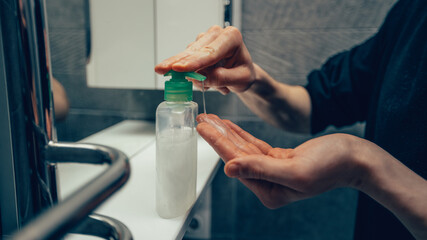 close up. man using a bactericidal hand soap.